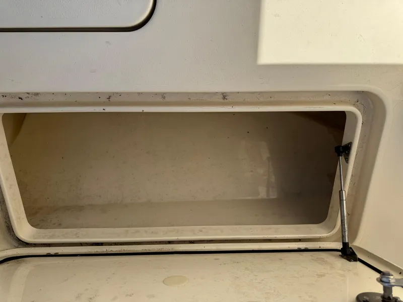 Slide: The Image of 2024 Scout 33LXF storage compartment, open and empty, with hydraulic support. - 17