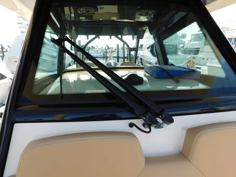 Slide: The Image of 2024 Scout 33LXF boat windshield with wipers and interior view. - 19