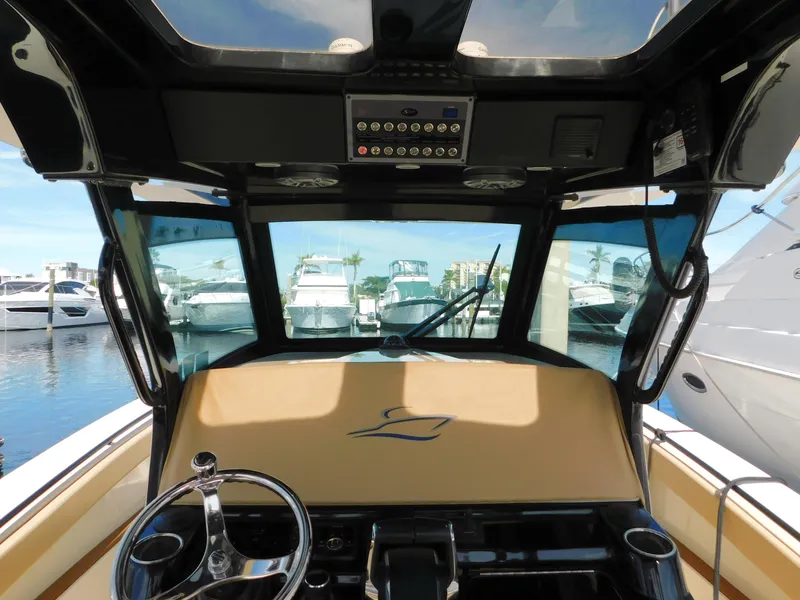 Slide: The Image of Interior view of 2024 Scout 33LXF boat cockpit with steering wheel and dashboard. - 22