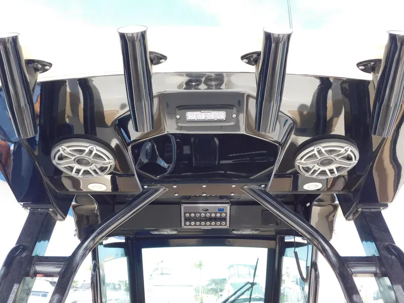 Slide: The Image of 2024 Scout 33LXF boat interior with speakers and rod holders. - 23
