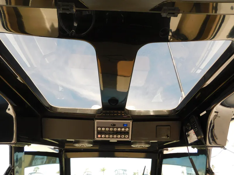 Slide: The Image of 2024 Scout 33LXF boat interior with skylight and control panel. - 24