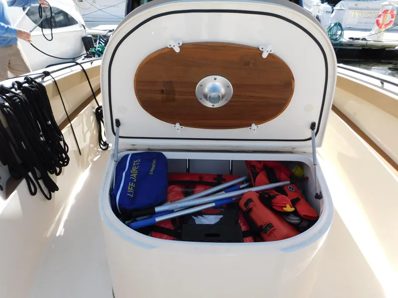 Slide: The Image of 2024 Scout 33LXF boat storage compartment with safety gear and equipment. - 30