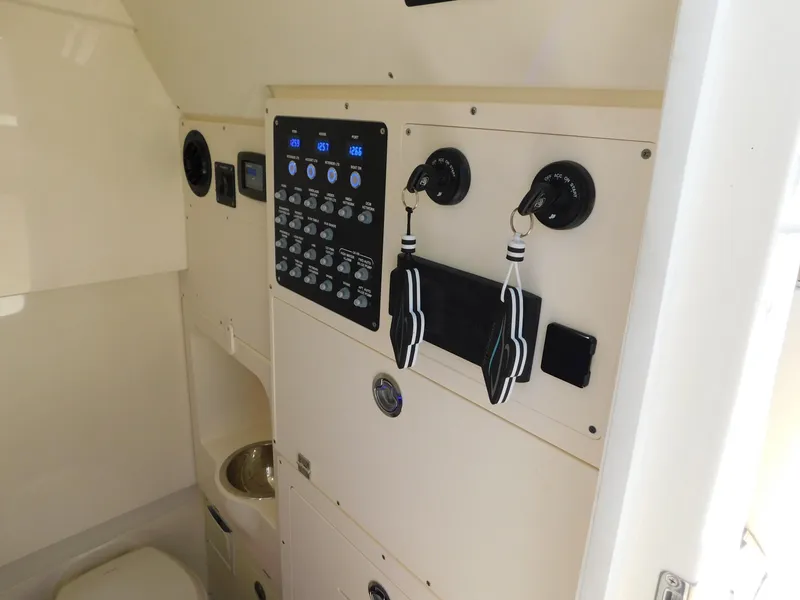 Slide: The Image of 2024 Scout 33LXF boat interior control panel and equipment. - 33
