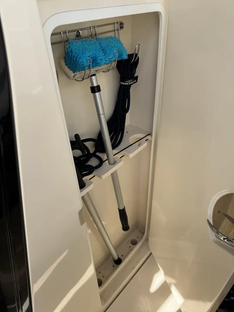 Slide: The Image of 2024 Scout 33LXF storage compartment with cleaning tools and accessories. - 37