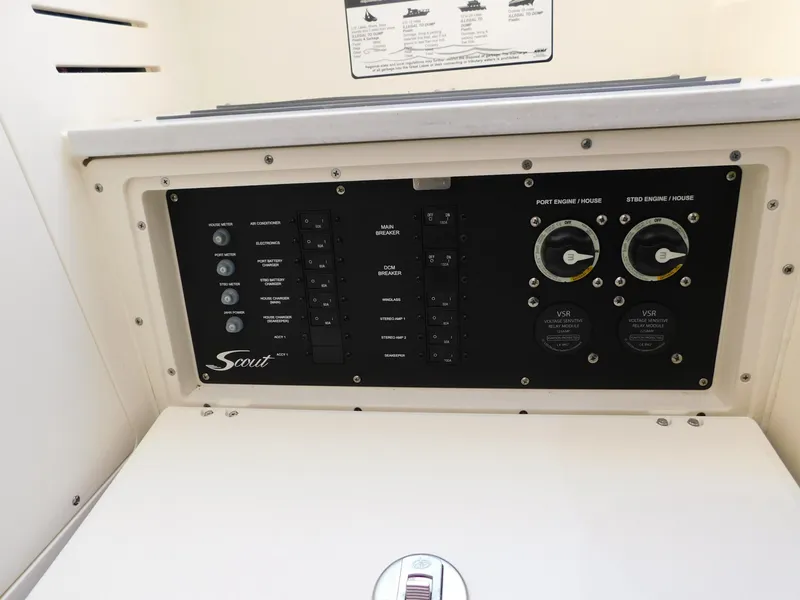 Slide: The Image of Control panel of 2024 Scout 33LXF boat with switches and gauges. - 38
