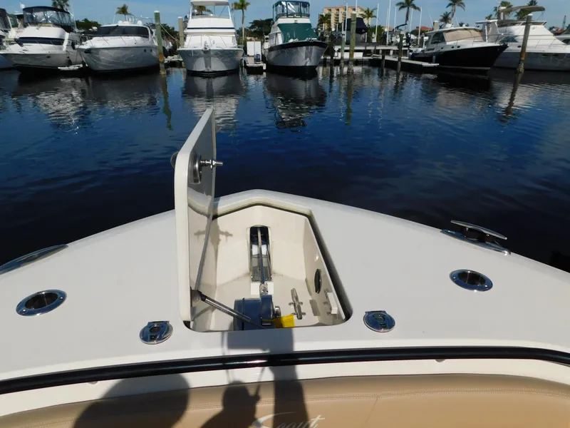 Slide: The Image of 2024 Scout 33LXF boat bow with anchor compartment, docked at marina. - 39