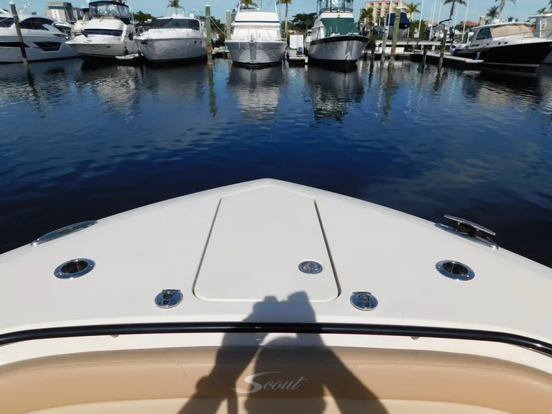 Slide: The Image of 2024 Scout 33LXF boat docked in marina, surrounded by other boats. - 40