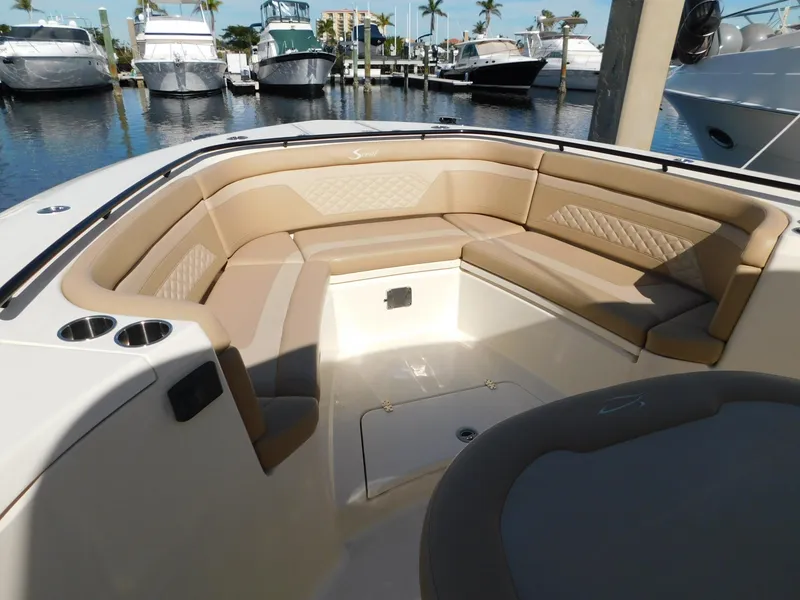 Slide: The Image of Luxurious seating area on 2024 Scout 33LXF boat, docked at marina. - 43