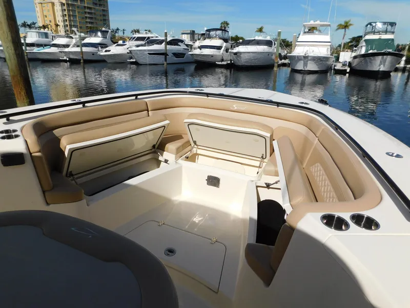 Slide: The Image of 2024 Scout 33LXF boat interior with open storage compartments at marina. - 44
