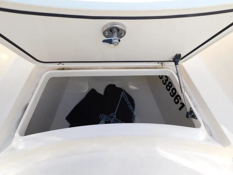 Slide: The Image of 2024 Scout 33LXF boat storage compartment with chain and lock mechanism. - 45