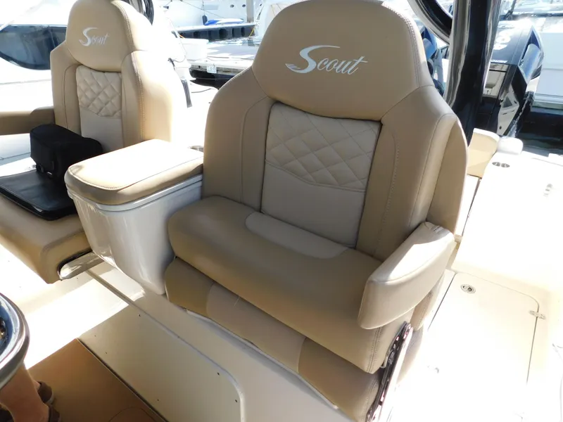 Slide: The Image of 2024 Scout 33LXF boat seats with beige leather upholstery and embroidered logo. - 47