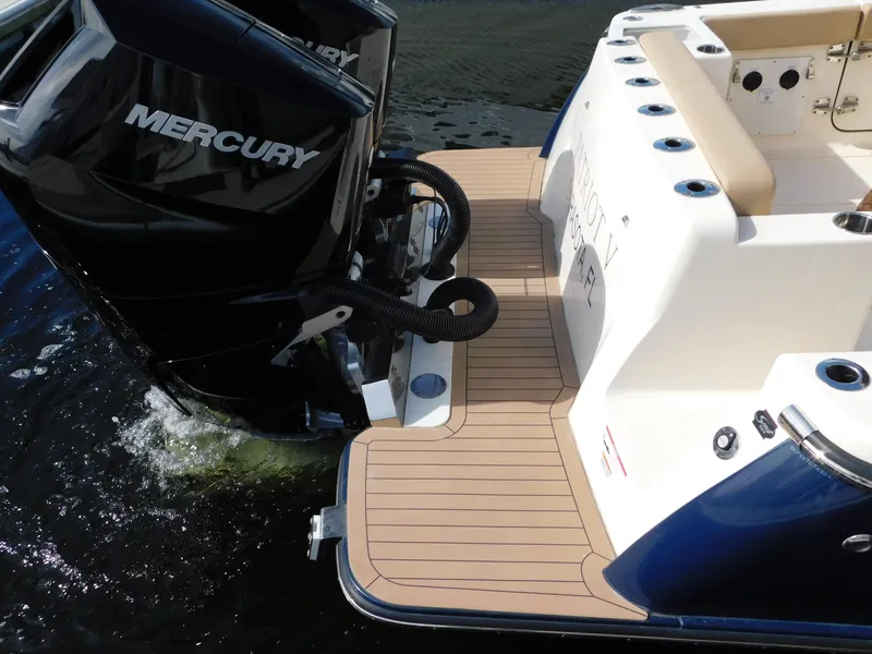 Slide: The Image of 2024 Scout 33LXF boat with Mercury outboard engine on water. - 7