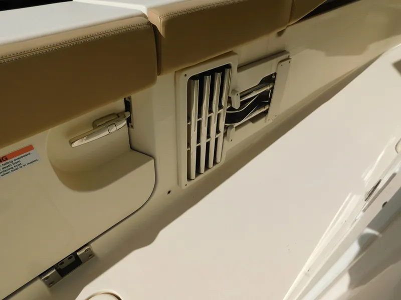 Slide: The Image of 2024 Scout 33LXF boat interior detail with beige seating and ventilation grille. - 9