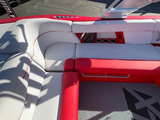 Slide: The Image of 2020 MasterCraft XT22 interior with red and white seating, modern design, and premium materials. - 13