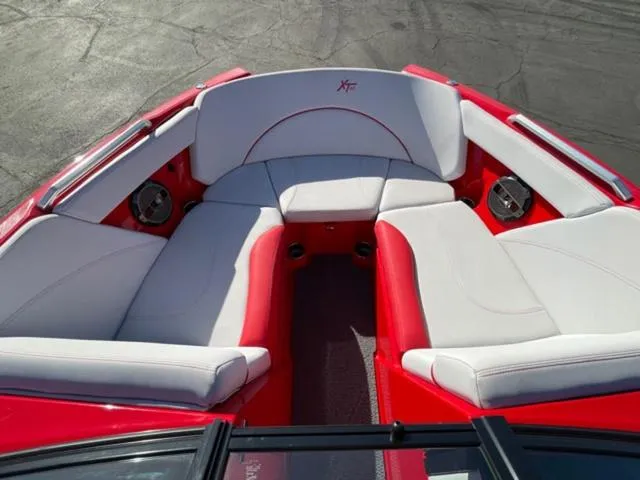 Slide: The Image of 2020 MasterCraft XT22 boat interior with red and white seating. - 16
