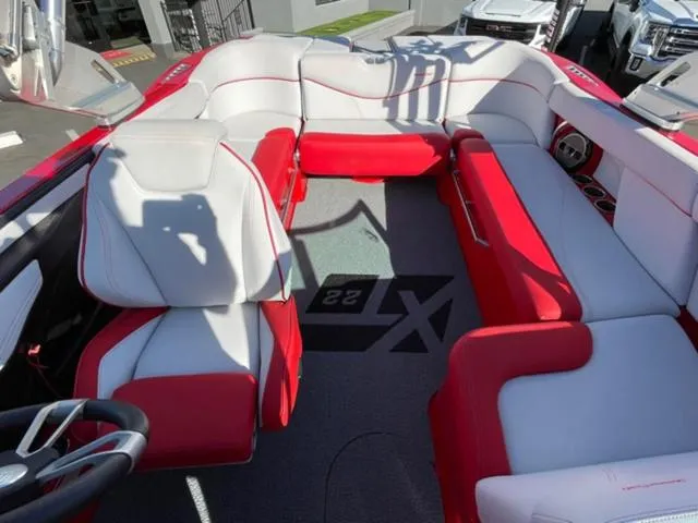 Slide: The Image of 2020 MasterCraft XT22 boat interior with red and white seating. - 17
