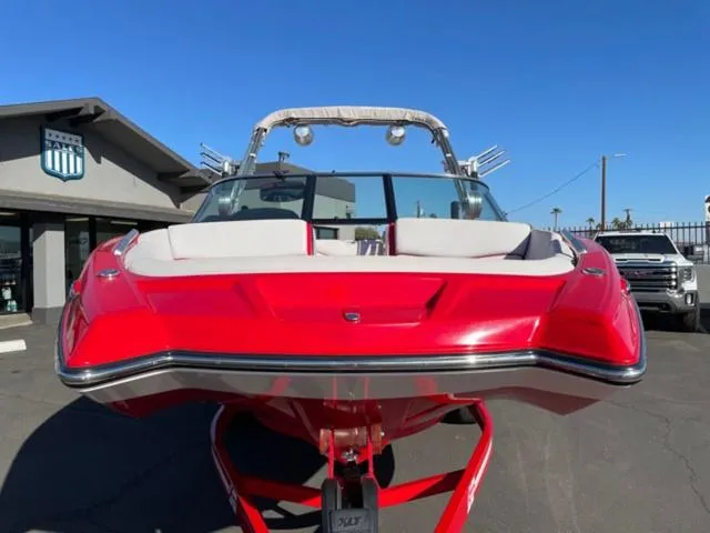 Slide: The Image of Red 2020 MasterCraft XT22 boat parked outdoors on a sunny day. - 3
