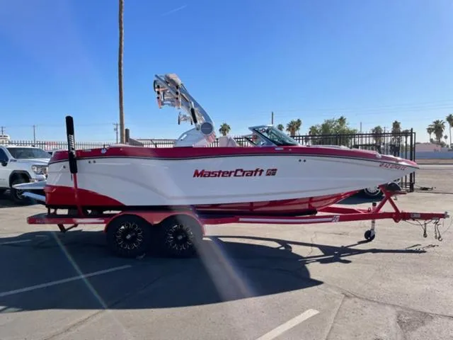 Slide: The Image of 2020 MasterCraft XT22 boat on trailer in sunny parking lot. - 5