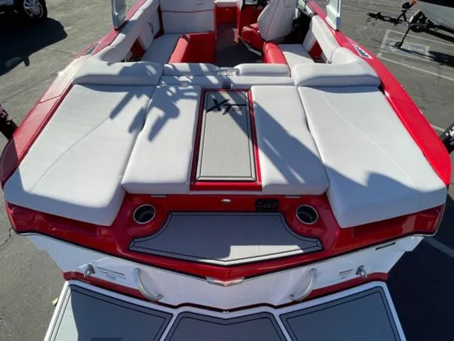 Slide: The Image of 2020 MasterCraft XT22 boat interior with red and white seating and sleek design. - 9