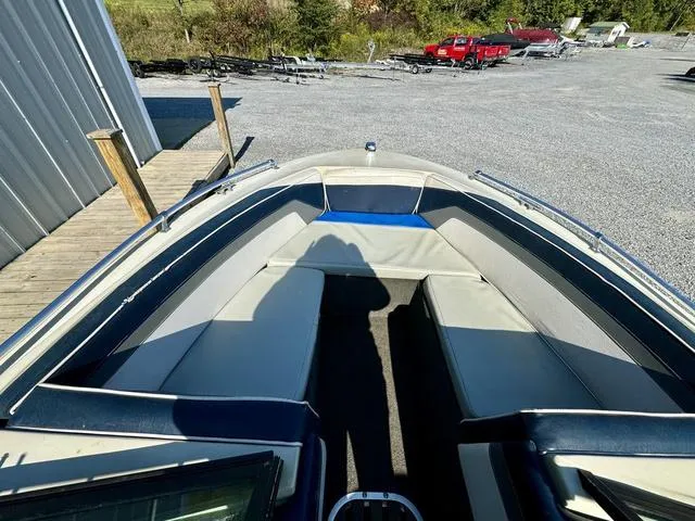 Slide: The Image of 1989 Glassport 175 BR boat interior with seating, parked on gravel lot. - 10