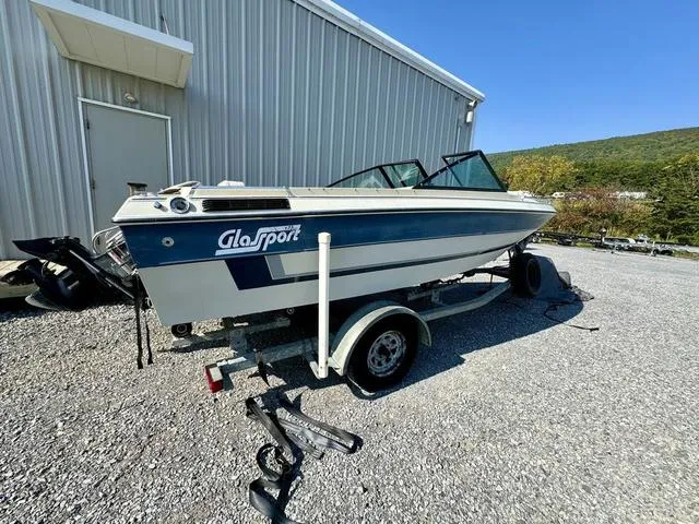 Slide: The Image of 1989 Glassport 175 BR boat on trailer, parked beside a metal building. - 6