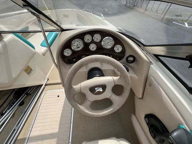 Slide: The Image of 2002 Stingray 200LS/LX boat dashboard with steering wheel and gauges. - 16