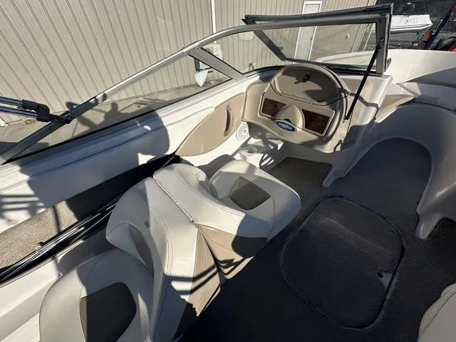 Slide: The Image of 2005 Four Winns 190 Horizon boat interior with steering wheel and seating. - 12