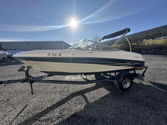 Slide: The Image of 2005 Four Winns 190 Horizon boat on trailer under bright sun. - 13