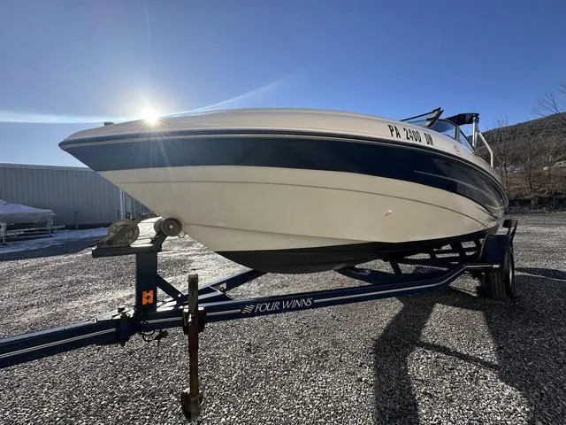 Slide: The Image of 2005 Four Winns 190 Horizon boat on trailer, sunlit, gravel lot. - 14