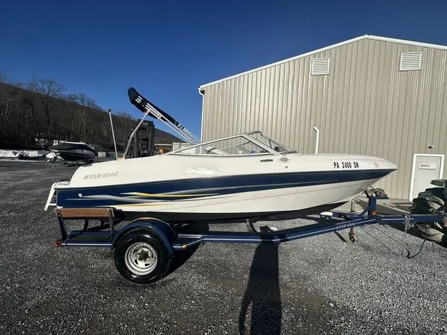 Slide: The Image of 2005 Four Winns 190 Horizon boat on trailer, parked outdoors near a building. - 3