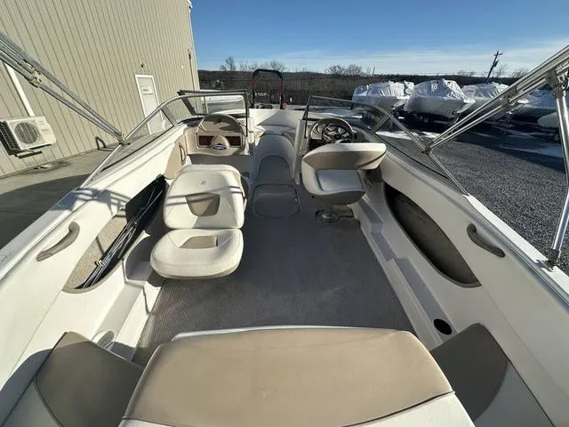 Slide: The Image of 2005 Four Winns 190 Horizon boat interior with beige seating and steering wheel. - 4
