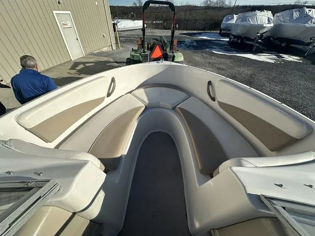 Slide: The Image of 2005 Four Winns 190 Horizon boat interior with beige seating, parked outdoors. - 7