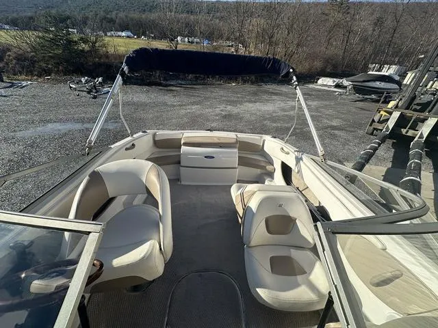 Slide: The Image of 2005 Four Winns 190 Horizon boat interior with beige seating and open deck. - 8