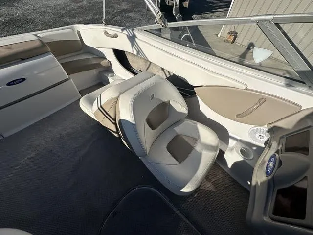 Slide: The Image of 2005 Four Winns 190 Horizon boat interior with beige and white seating. - 9