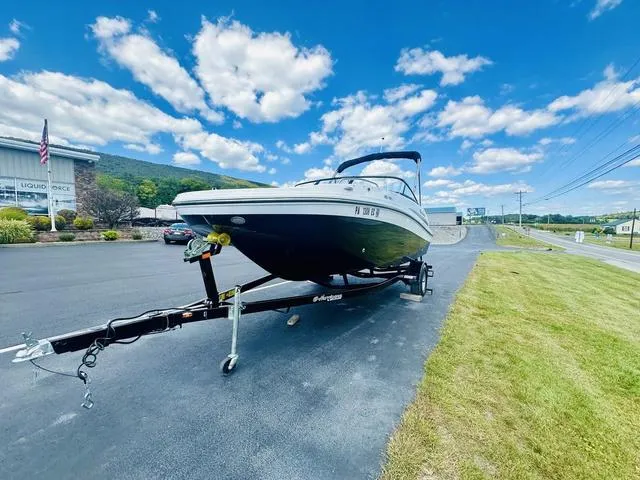 Slide: The Image of 2022 Hurricane SunDeck 191 OB boat on trailer under blue sky. - 10