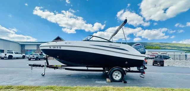 Slide: The Image of 2022 Hurricane SunDeck 191 OB boat on trailer, parked outdoors under blue sky. - 11