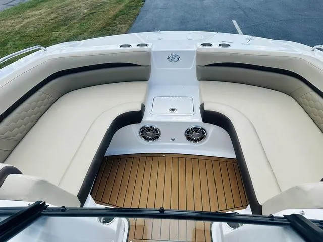 Slide: The Image of 2022 Hurricane SunDeck 191 OB boat interior with beige seating and wood flooring. - 15