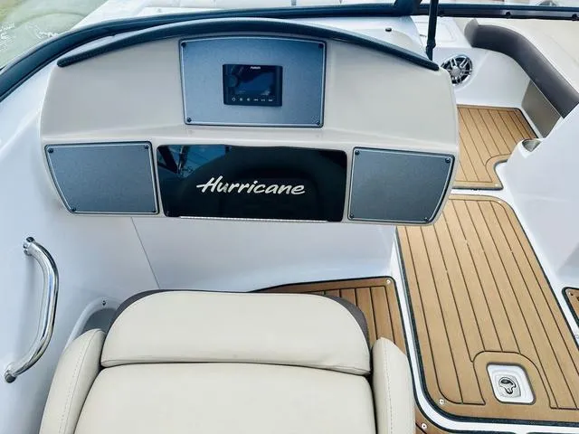 Slide: The Image of 2022 Hurricane SunDeck 191 OB boat interior with sleek dashboard and wood-style flooring. - 16