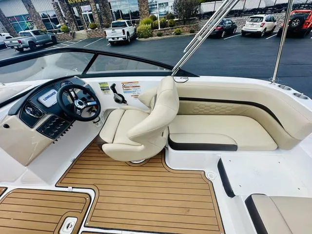 Slide: The Image of 2022 Hurricane SunDeck 191 OB boat interior with beige seating and wood-style flooring. - 17