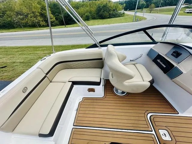 Slide: The Image of 2022 Hurricane SunDeck 191 OB boat interior with beige seating and wood-style flooring. - 18