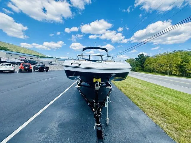 Slide: The Image of 2022 Hurricane SunDeck 191 OB boat on trailer, parked on asphalt near grassy roadside. - 19