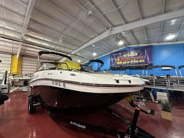 Slide: The Image of 2022 Hurricane SunDeck 191 OB boat displayed in indoor showroom. - 20