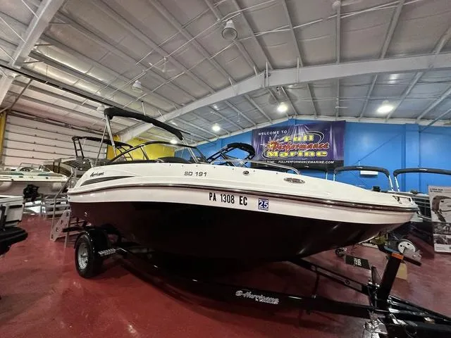 Slide: The Image of 2022 Hurricane SunDeck 191 OB boat displayed in indoor showroom. - 3