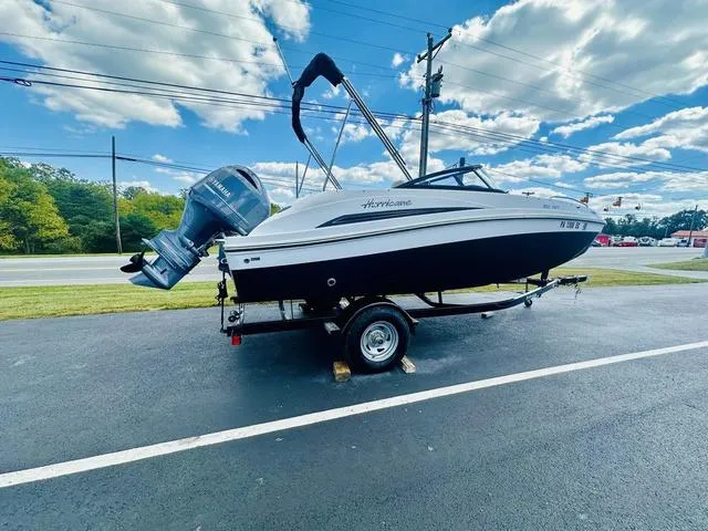 Slide: The Image of 2022 Hurricane SunDeck 191 OB boat on trailer under blue sky. - 7