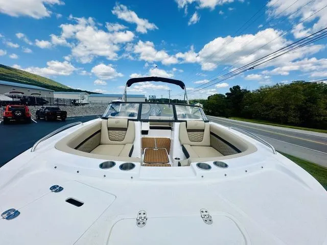 Slide: The Image of 2022 Hurricane SunDeck 191 OB boat with spacious seating, under a clear blue sky. - 9