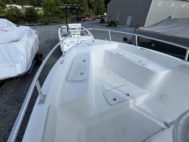 Slide: The Image of 2001 Carolina Skiff 2100 boat with spacious deck, parked outdoors. - 11