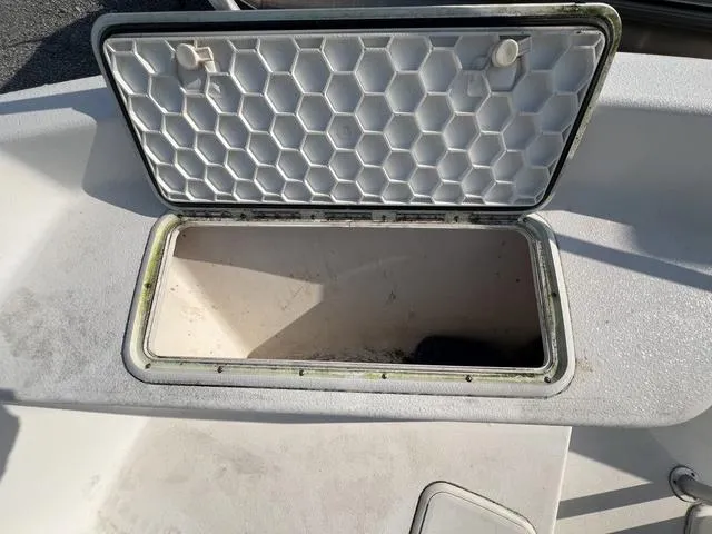 Slide: The Image of Open storage compartment on a 2001 Carolina Skiff 2100 boat. - 14
