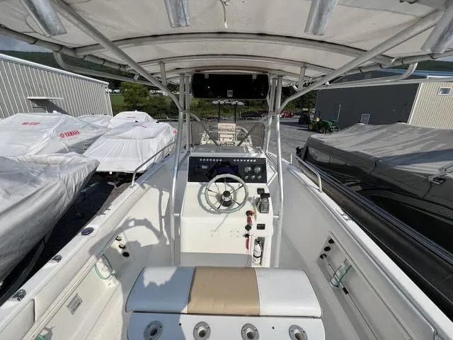Slide: The Image of 2001 Carolina Skiff 2100 boat interior with steering console and covered seats. - 15