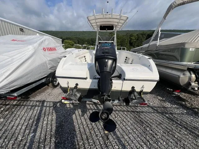 Slide: The Image of 2001 Carolina Skiff 2100 boat with outboard motor, parked on gravel lot. - 3