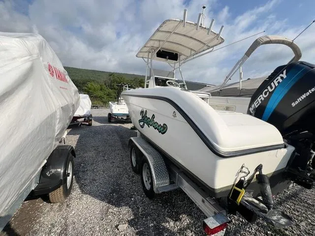 Slide: The Image of 2001 Carolina Skiff 2100 boat on trailer with Mercury engine, parked outdoors. - 4